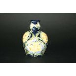 MOORCROFT FLORIAN VASE a small vase painted with a floral design, in blue, green and yellow. Painted