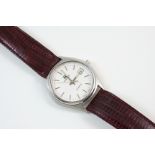 A GENTLEMAN'S STAINLESS STEEL WRISTWATCH BY TISSOT the signed circular dial with baton numerals,