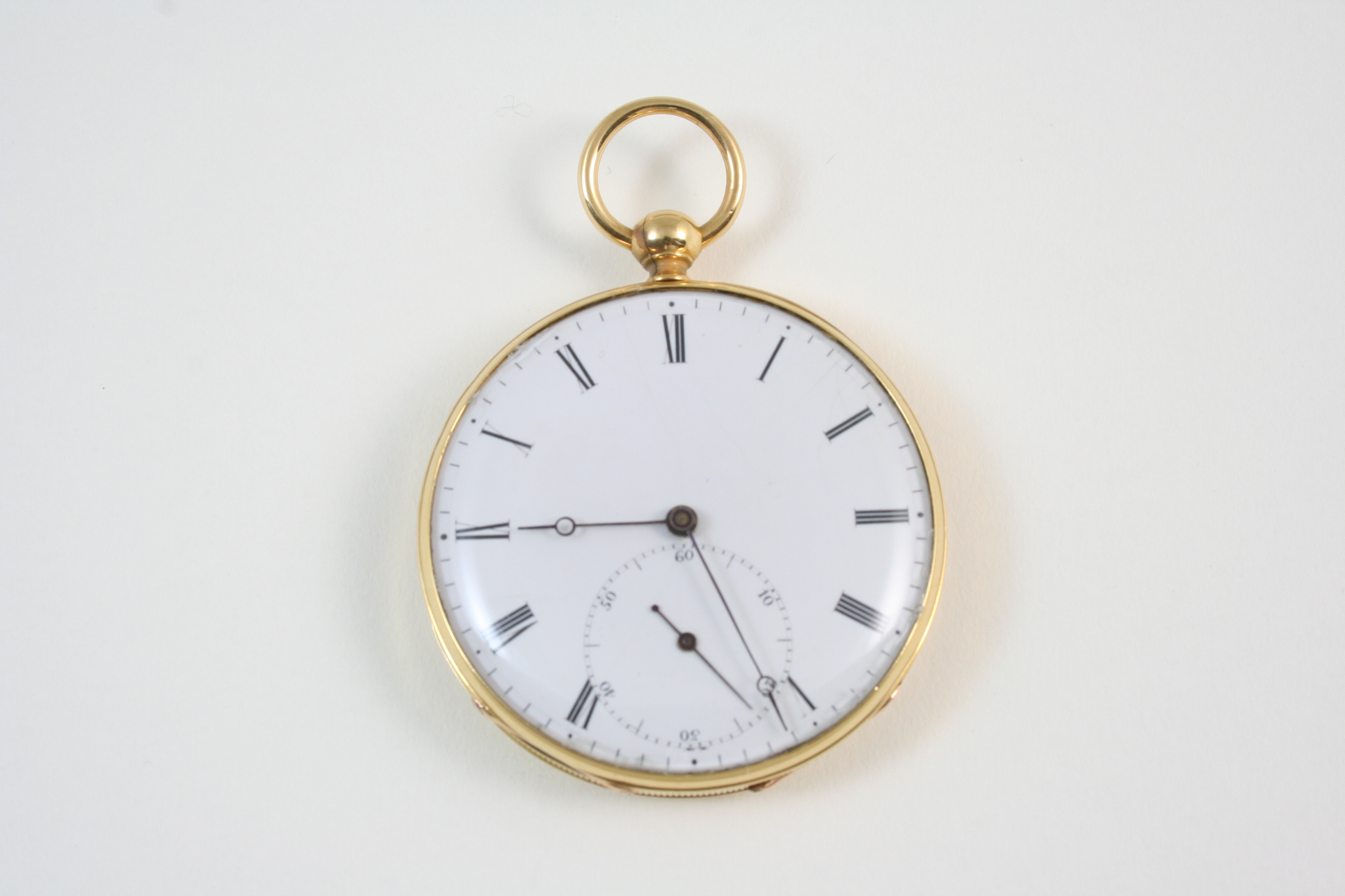 A GOLD OPEN FACED POCKET WATCH the white enamel dial with Roman numerals and subsidiary seconds