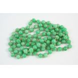 A SINGLE ROW UNIFORM JADE BEAD NECKLACE the jade beads measure approximately 8.7mm., 108cm. long.