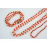 A DOUBLE ROW CORAL BEAD AND CULTURED PEARL NECKLACE 47.5cm. long, together with a three row
