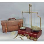 A SET OF LATE VICTORIAN BRASS TRAVELLING SCALES with seven brass weights and two spring balances,