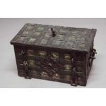 A 17TH CENTURY IRON STRONG BOX with lock in the lid, the exterior with painted panels between