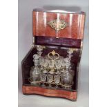 A FRENCH DECANTER BOX burr wood with inlaid brass panels, the interior with four decanters and