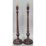 A PAIR OF MAHOGANY TABLE LAMPS with spirally fluted columns Height 23" (58.5cm)