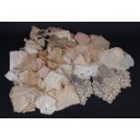A BAG OF NEEDLE LACE TRIMS, COLLARS & VANITY VESTS A bag of lace containing 19th century hand worked