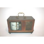 CASED BAROGRAPH by F Darton & Co London, in a metal case and with a clockwork mechanism. 26cms