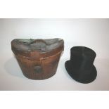 LEATHER CASED TOP HAT a fitted leather case containing a black silk top hat by Laird, Belfast. The