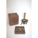 CASED MICROSCOPE - NEGRETTI & ZAMBRA a brass and metal monocular microscope which is put together in