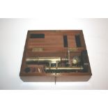 CASED MICROSCOPE a brass and metal monocular microscope by E Leitz, Wetzlar, with one additional