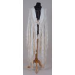 A 1920'S CREAM SILK CLOAK & SHAWL Heavy cream silk with fringed edges and tassel fastenings and a
