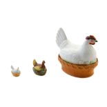* A Continental Porcelain Tureen   in the form of a hen seated on a nest, together with two