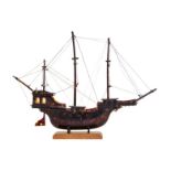 A Hand Carved Tortoise Shell Model of a Ship   19th/20th century   with three masts, raised on a