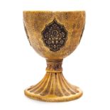 * A Ceramic Chalice   20th century   having floral decorated cartouches on a gilt ground, with brass