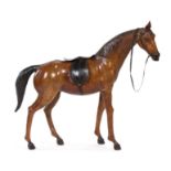 * A Tooled and Painted Leather Model of a Horse   having a European model saddle mounted on his