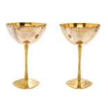 * A Pair of Silver and Silver-Gilt Commemorative Goblets   Stuart Devlin, 1973   each raised on a