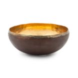 * A Michael Aram Copper Bowl   with a gilt interior, signed underneath   Diameter 8 1/4 inches.