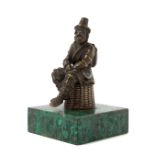 * A Continental Gilt Bronze Figure   late 19th century   depicting a seated traveler on a