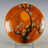 A Japanese porcelain plate, Meiji Period, decorated with prunus blossom, signed, 24.5cm diameter