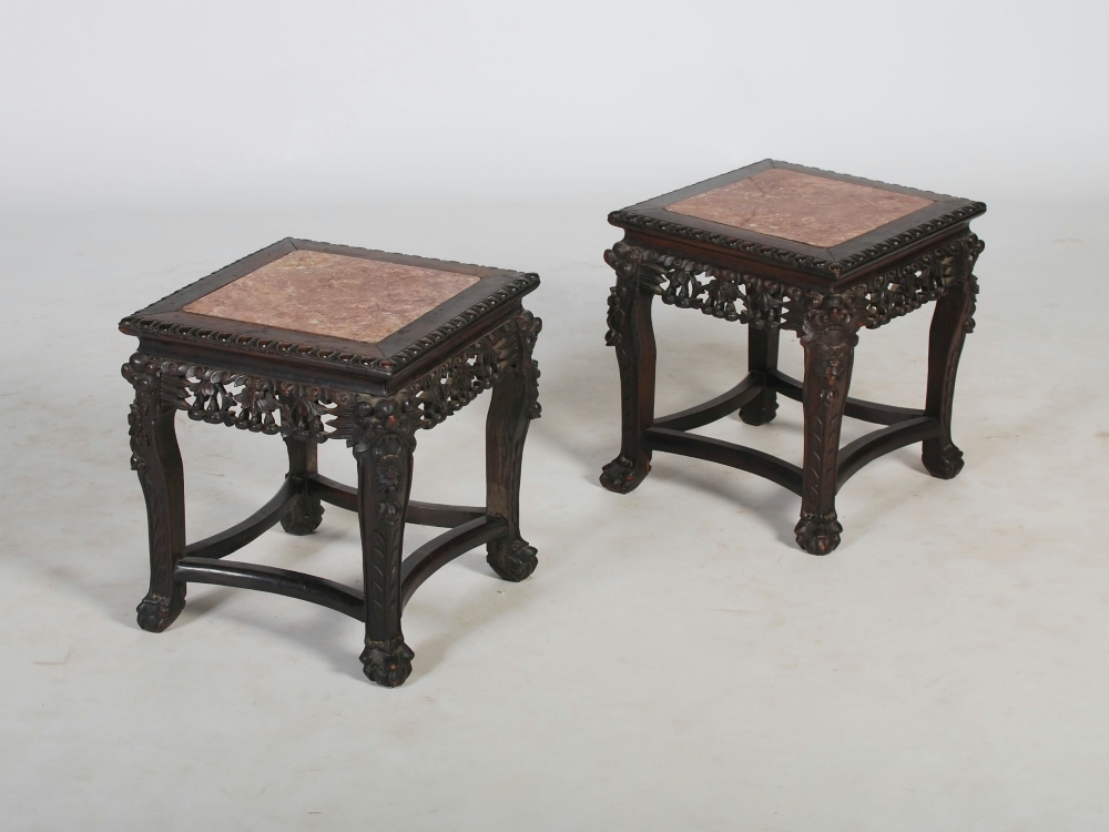 A pair of Chinese dark wood jardiniere stands, Qing Dynasty, the square shaped tops with mottled red