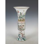 A Chinese porcelain famille verte beaker vase, decorated with rockwork issuing blossom, peony and