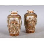 A pair of Japanese Satsuma pottery vases in the style of Meizan, Meiji Period, decorated with oval