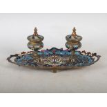 A late 19th/ early 20th century gilt metal and champleve enamel desk stand, set with two inkwells