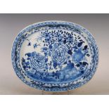 A Chinese porcelain blue and white oval-shaped dish, Qing Dynasty, decorated with a fenced garden of