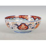 A late 19th/ early 20th century Japanese Imari bowl, decorated with a scroll-shaped panel