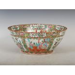 A Chinese porcelain Canton famille rose bowl, Qing Dynasty, decorated with panels of figures divided