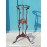 A George III style mahogany washstand, the open circular top raised on turned columns above a