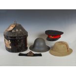 An early 20th century Royal Artillery Officers dress hat, a Pith hat, an A.R.P helmet and a Japanned