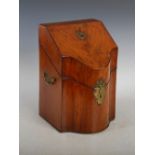 A George III mahogany serpentine knife box, the hinged cover opening to a fitted interior of