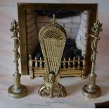 A brass fire screen and a pair of brass andirons, the fire screen with hinged and pierced fan shaped