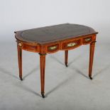 A late 19th century walnut, gilt metal and porcelain mounted writing table, the shaped rectangular