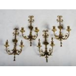 A set of four Neo-Classical style gilt metal two light wall sconces, the urn shaped lights supported