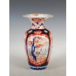 A Japanese Imari vase, decorated with four shaped rectangular panels enclosing birds, flowers and