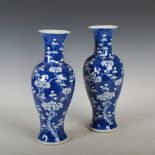 A pair of Chinese porcelain blue and white vases, four character Kangxi marks but later, decorated