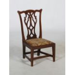 A late 19th/ early 20th century mahogany gossip chair, with drop in needlework upholstered seat
