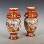 A pair of Japanese Kutani twin handled vases, Meiji Period, decorated with panels of figures and