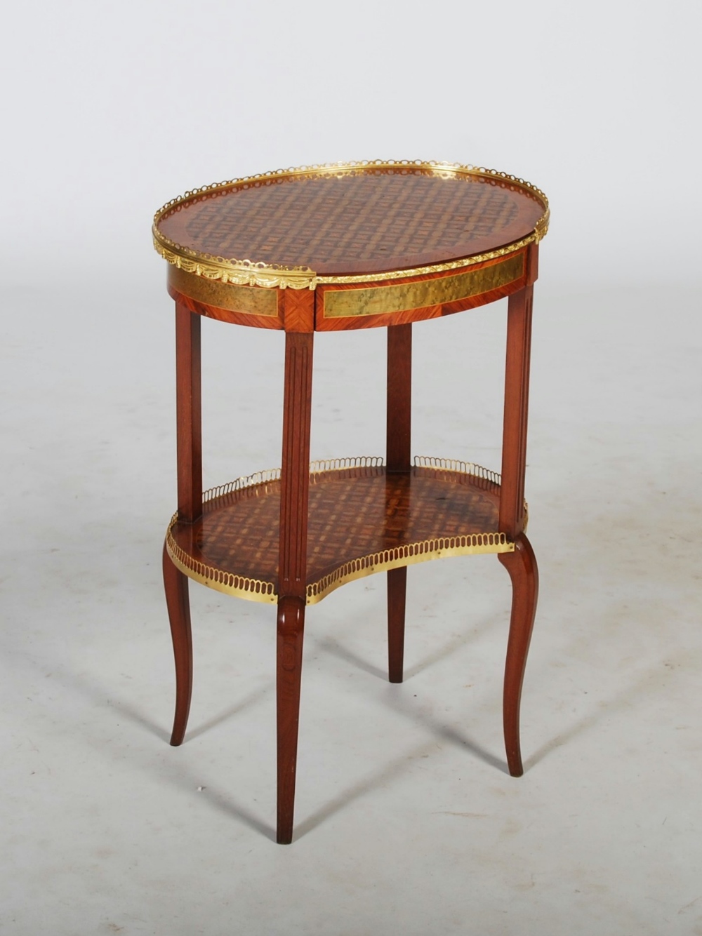 An early 20th century kingwood, parquetry inlaid and gilt metal mounted occasional table, the oval