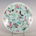 A Chinese porcelain celadon ground famille rose plate, Qing Dynasty, decorated with flowers,