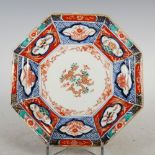 A Japanese Imari octagonal-shaped plate, decorated with a pine branch within a floral panelled