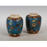 A pair of Japanese Satsuma pottery blue ground jars, Meiji Period, with cloisonne type decoration of