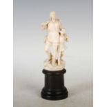 A late 19th century ivory figure of huntsman and boy, possibly Dieppe, the huntsman holding a