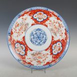 A late 19th/ early 20th century Japanese Imari charger, decorated with a central foliate roundel