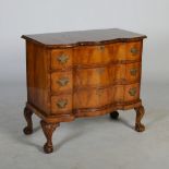 An early 20th century walnut serpentine chest, the shaped top with a moulded edge above three long