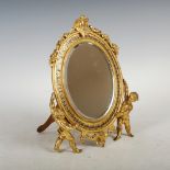 A late 19th/ early 20th century ormolu and champleve enamel dressing table mirror, the bevelled oval