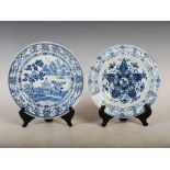 Two Chinese porcelain blue and white plates, Qing Dynasty, one decorated with pavilions and sampan