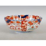 A late 19th/ early 20th century Japanese Imari bowl, decorated with a central roundel enclosing a